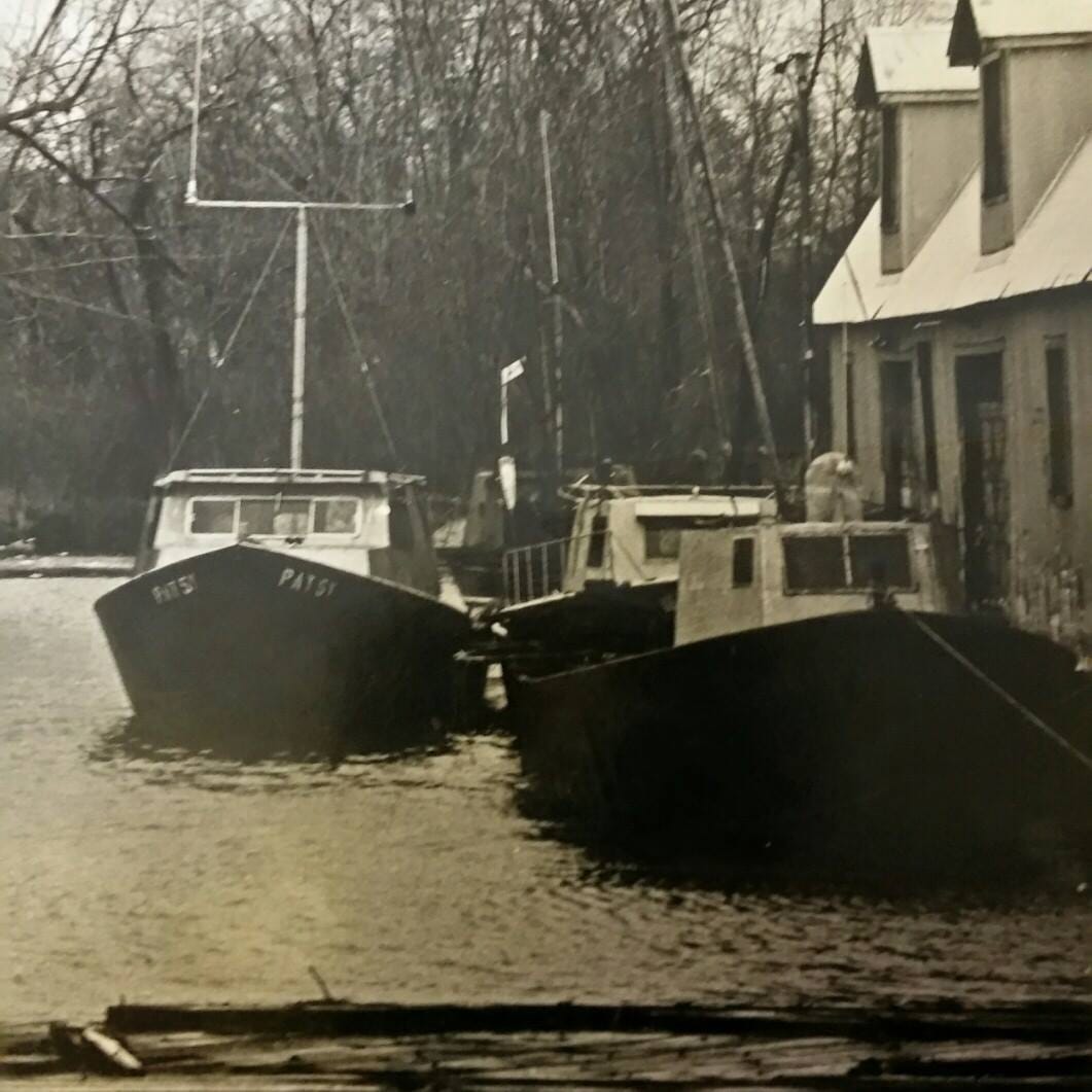 Patsy, Tawas, Sunflower III, and the Sea Captain docked at the Net Shed, 1980s.
